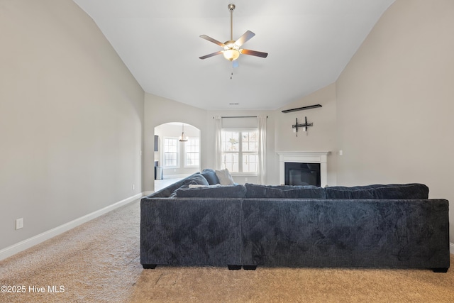 carpeted living room featuring vaulted ceiling and ceiling fan