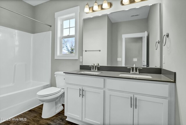 74 Talbert Dr, Rocky Point, NC 28457 - full bathroom with hardwood / wood-style flooring, washtub / shower combination, vanity, and toilet