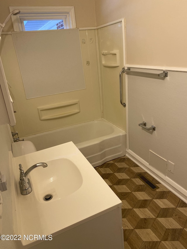 bathroom featuring sink and washtub / shower combination