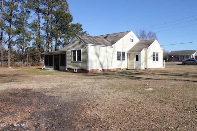 view of front of property with a sunroom and a front yard