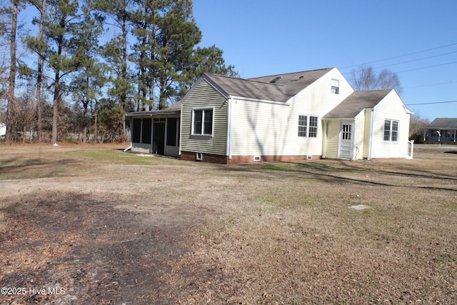 view of front of house featuring a sunroom and a front yard