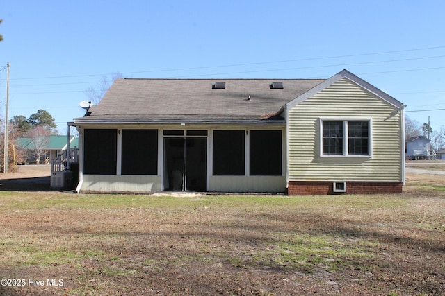 back of house with a yard and a sunroom