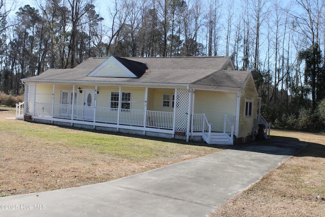 view of front of home with a porch and a front lawn