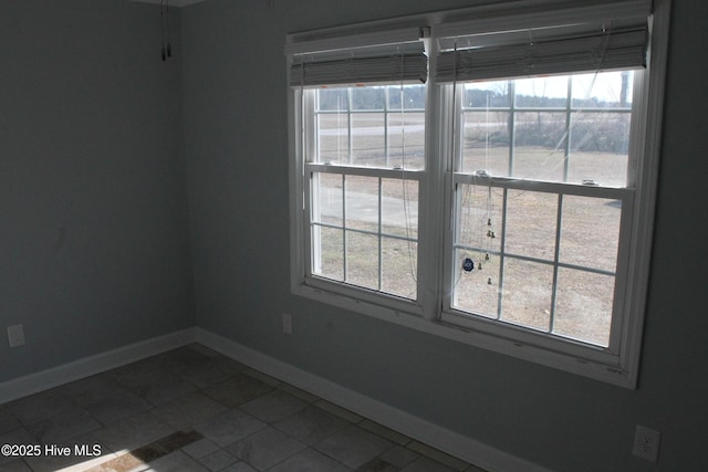 unfurnished room featuring tile patterned floors