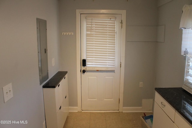 doorway with electric panel and light tile patterned floors