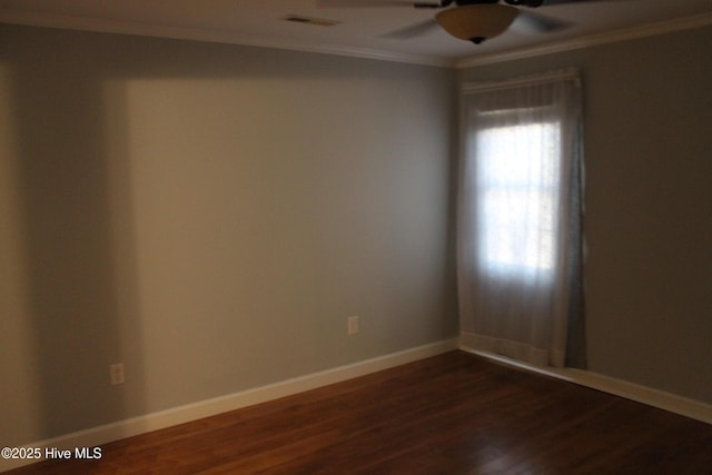 spare room featuring dark hardwood / wood-style flooring, ornamental molding, and ceiling fan