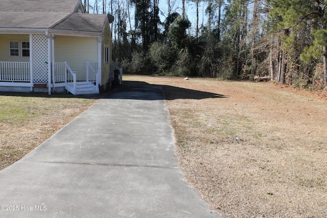 view of yard featuring covered porch