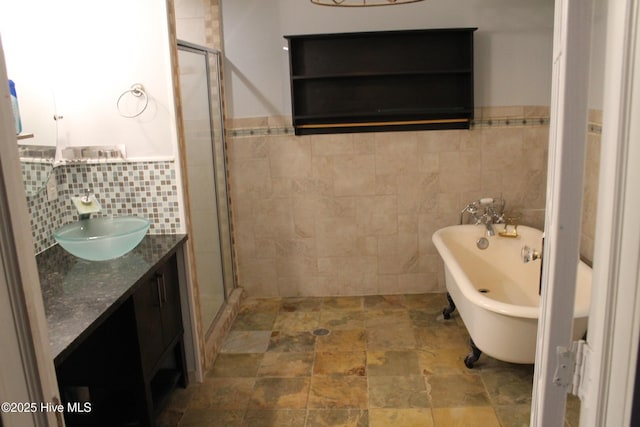 bathroom featuring tile walls, vanity, and shower with separate bathtub