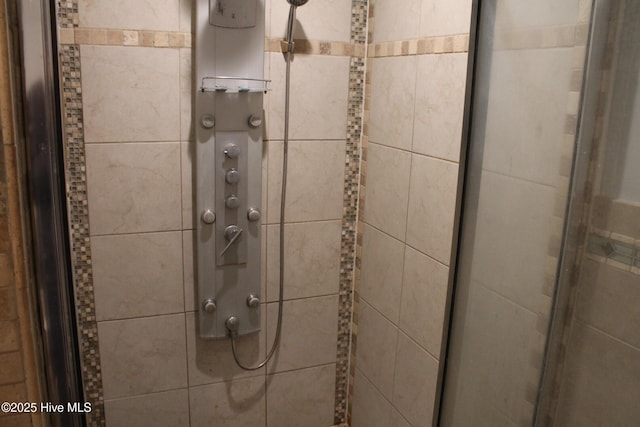 interior details with a shower with door