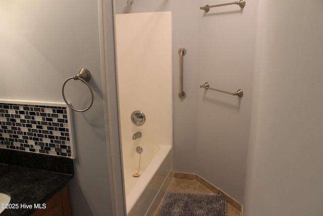 bathroom featuring vanity, backsplash, and tile patterned floors