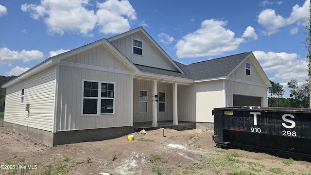 view of front of house featuring roof with shingles and covered porch