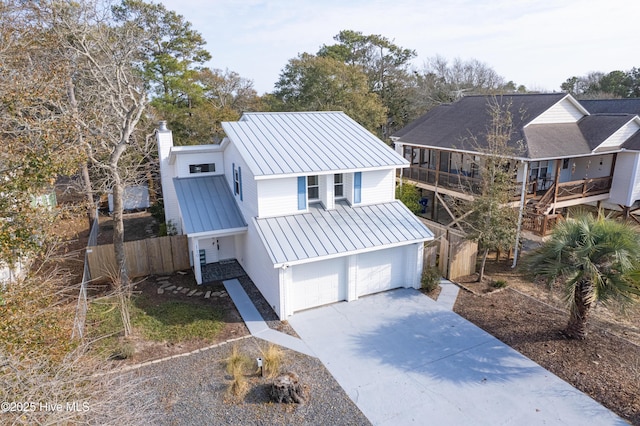 view of front facade with a garage and a sunroom