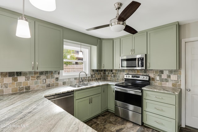 kitchen with stainless steel appliances, a sink, and green cabinets