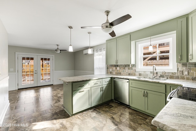 110 NE 29th St, Oak Island, NC 28465 - kitchen with green cabinets, stainless steel dishwasher, a peninsula, and a wainscoted wall