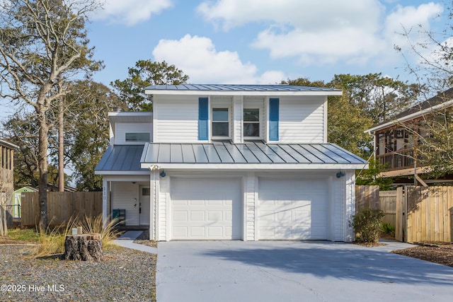 view of front of house with a standing seam roof, metal roof, and concrete driveway
