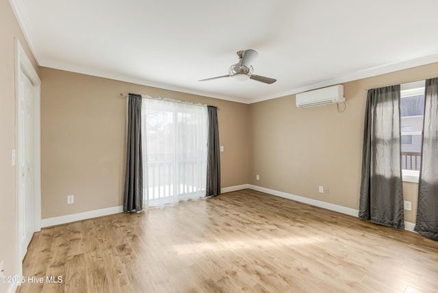 unfurnished room featuring a wall mounted AC, light wood-type flooring, a ceiling fan, baseboards, and ornamental molding