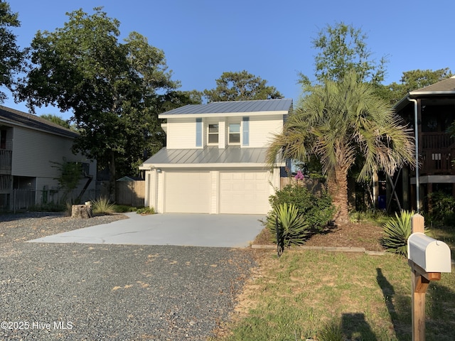 110 NE 29th St, Oak Island, NC 28465 - view of front of house with a garage, driveway, and a metal roof