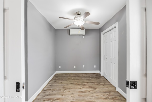 110 NE 29th St, Oak Island, NC 28465 - unfurnished bedroom featuring an AC wall unit, light wood-type flooring, a closet, and ceiling fan