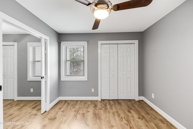 110 NE 29th St, Oak Island, NC 28465 - unfurnished bedroom with light wood-style floors, a ceiling fan, and a closet