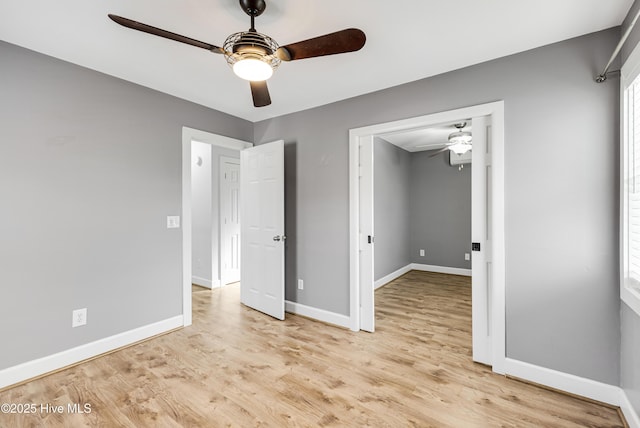 unfurnished bedroom with wood finished floors, ceiling fan, and baseboards