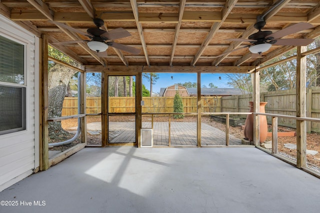 unfurnished sunroom with a ceiling fan