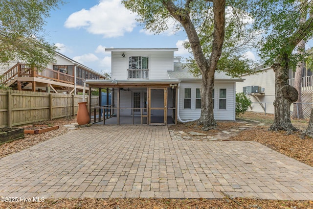 rear view of house featuring a patio area and a sunroom