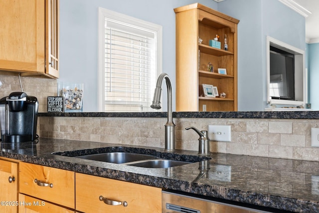 kitchen with sink, stainless steel dishwasher, decorative backsplash, and dark stone counters