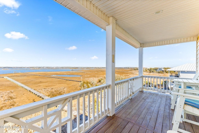 wooden deck with a rural view