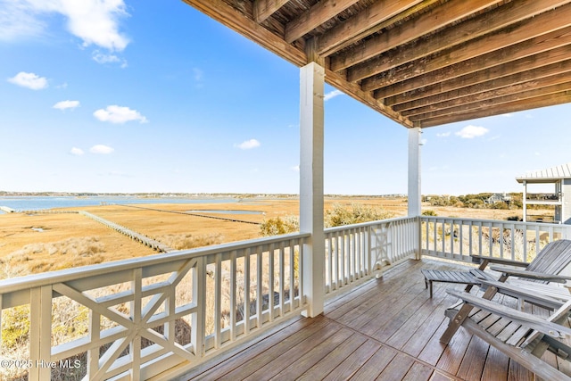 wooden terrace with a rural view and a water view