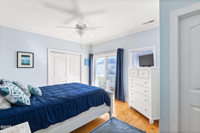 bedroom with crown molding, wood-type flooring, a closet, ceiling fan, and access to exterior