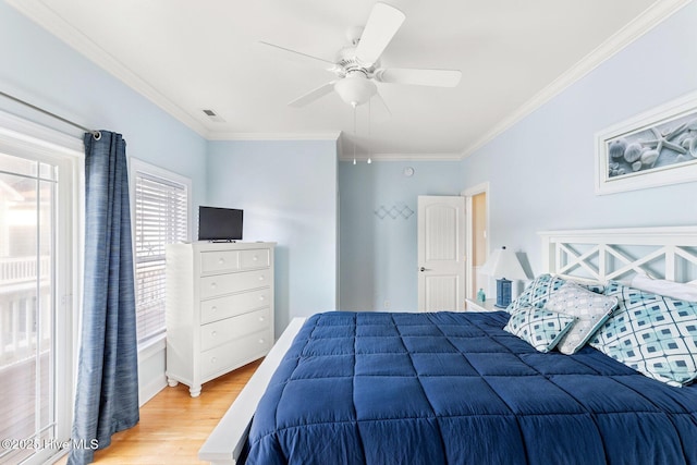 bedroom featuring ceiling fan, ornamental molding, and hardwood / wood-style floors