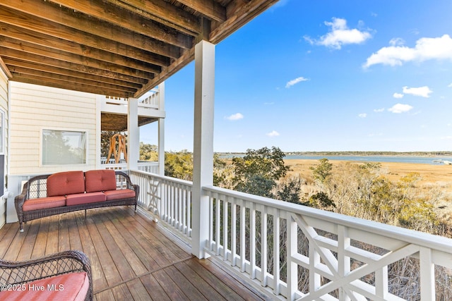 deck with an outdoor hangout area and a water view