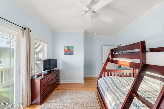 bedroom with ornamental molding, light hardwood / wood-style floors, and ceiling fan