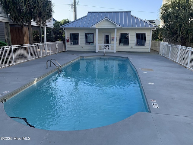 view of pool featuring an outbuilding and a patio