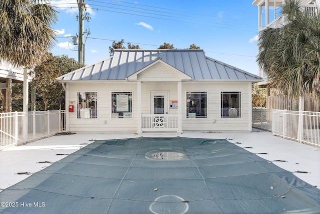 exterior space with a covered pool and a patio