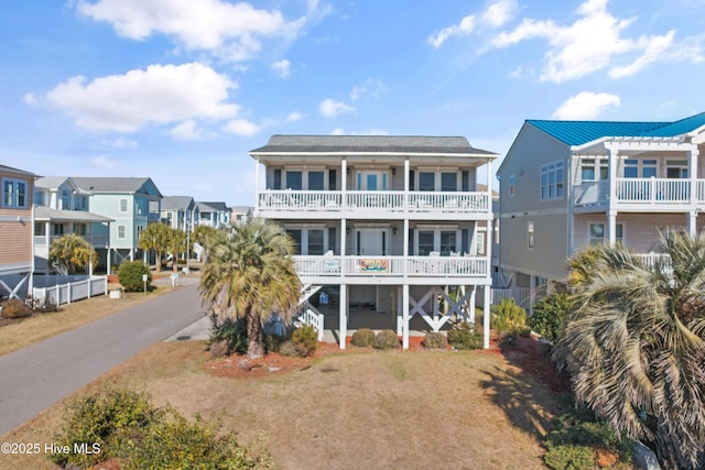 exterior space featuring a balcony and a yard