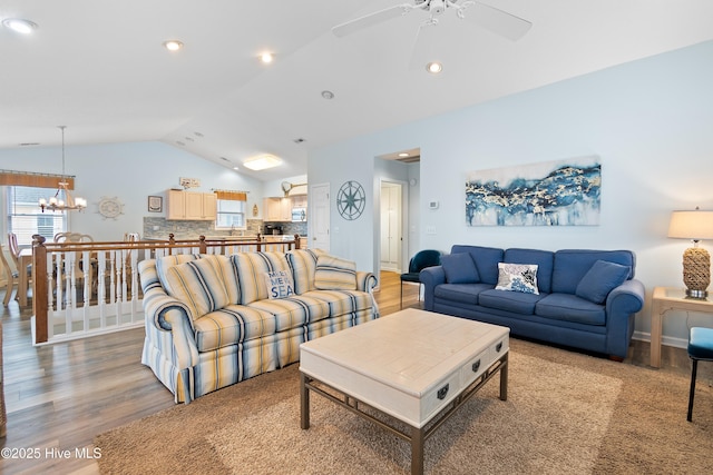 living room with lofted ceiling, a healthy amount of sunlight, and wood finished floors