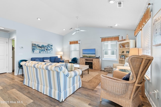 living area featuring recessed lighting, visible vents, vaulted ceiling, wood finished floors, and baseboards