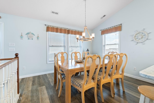 dining room featuring dark wood-type flooring, visible vents, vaulted ceiling, and an inviting chandelier