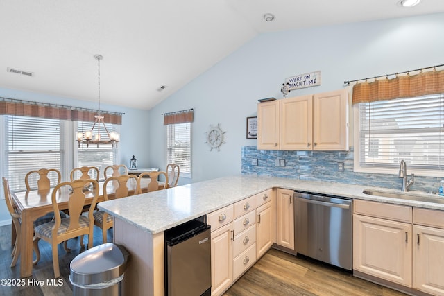 kitchen with visible vents, dishwasher, a peninsula, light brown cabinets, and a sink