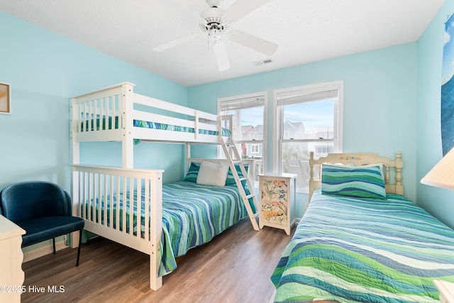 bedroom featuring visible vents, ceiling fan, and wood finished floors