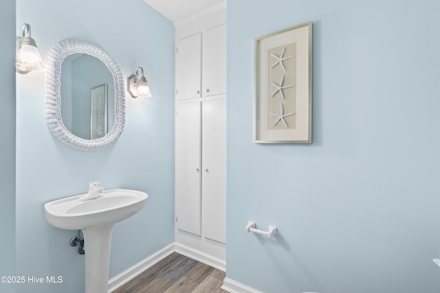 bathroom with baseboards and wood finished floors