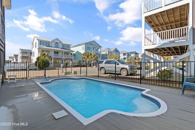 view of swimming pool with a residential view, fence, and a fenced in pool