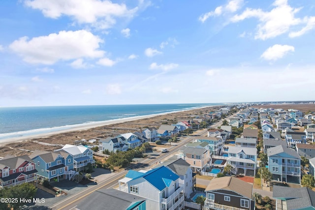 aerial view with a view of the beach, a water view, and a residential view