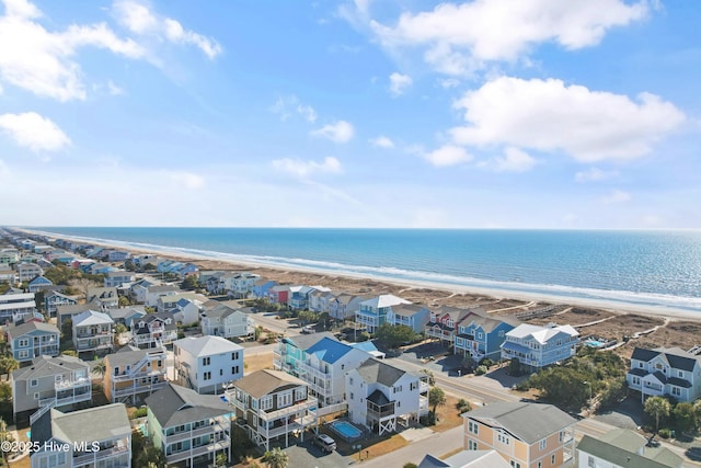 drone / aerial view featuring a water view, a residential view, and a view of the beach