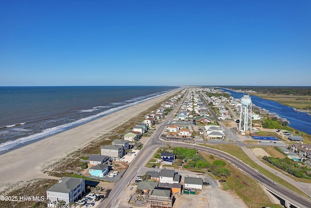 drone / aerial view with a water view and a beach view