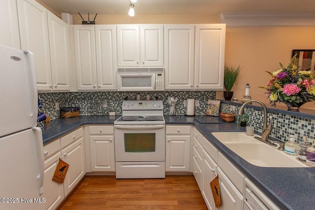 kitchen with sink, white cabinets, decorative backsplash, white appliances, and light hardwood / wood-style flooring