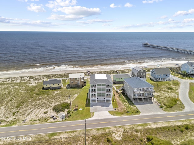 drone / aerial view with a beach view and a water view