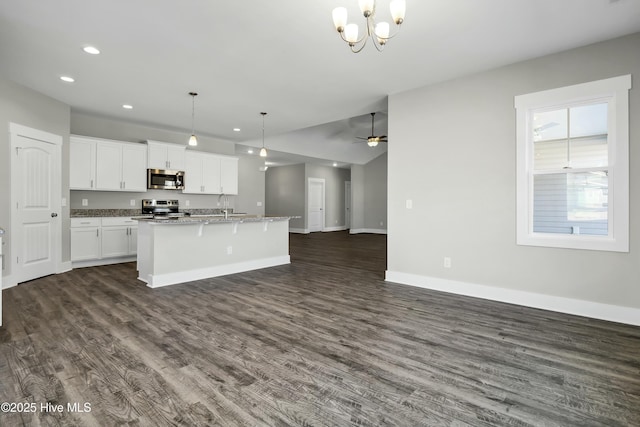 143 Talbert Dr, Rocky Point, NC 28457 - kitchen with a kitchen bar, decorative light fixtures, an island with sink, stainless steel appliances, and white cabinets
