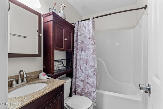 full bathroom with vanity, shower / bath combo, and toilet